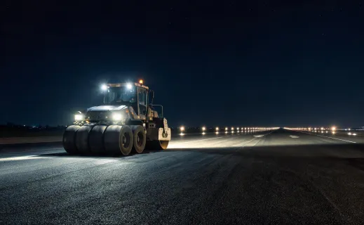 Pneumatic tire roller compacting airport taxiway asphalt