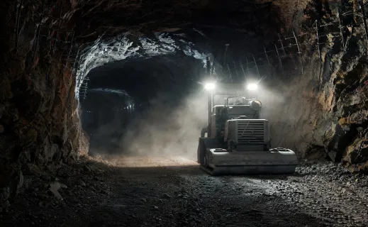 Plate compactor working on underground mine access road